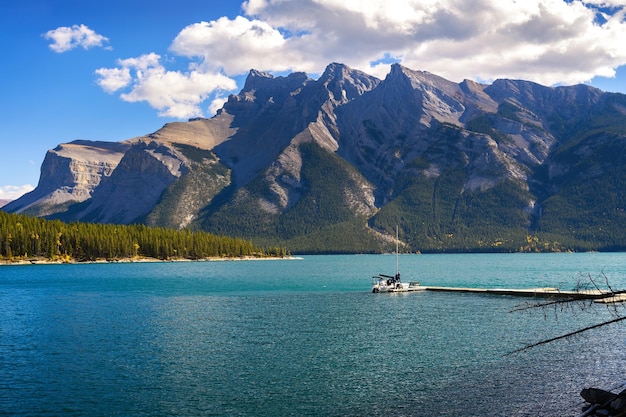 Boat with tourists on lake minnewanka in banff national park canada