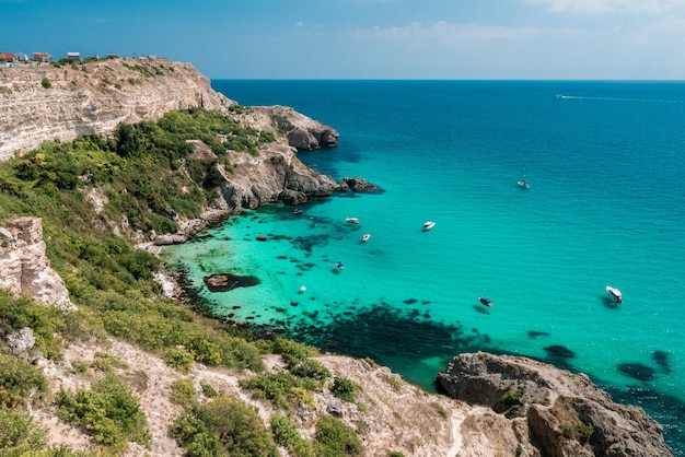 Boats on azure sea near baunty beach on fiolent