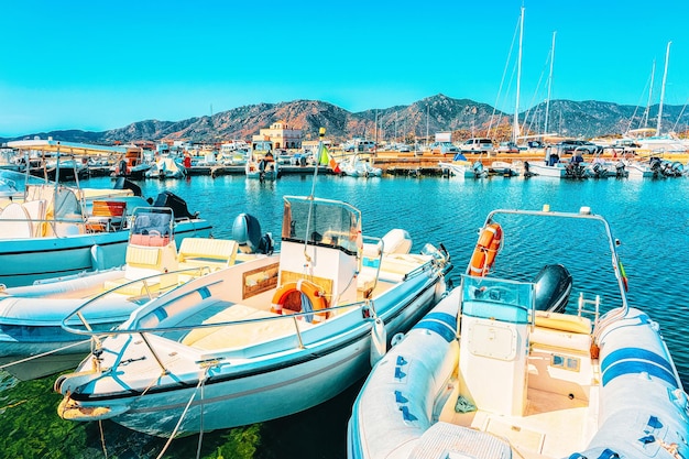 Boats in Beautiful Marina of Villasimius at the Bay of the Blue Waters of the Mediterranean Sea on Sardinia Island, in Italy in summer. Cagliari region.