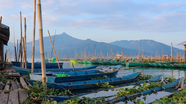 Boats in a lake with mountains in the background