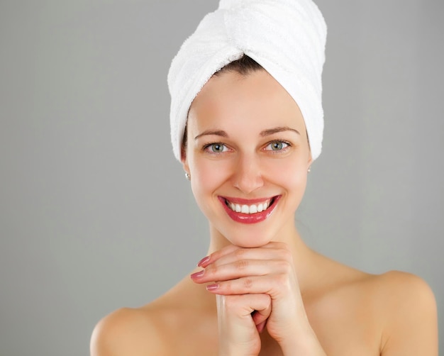 Body Care Beautiful young woman posing in white towel Spa healthcare isolated on grey background