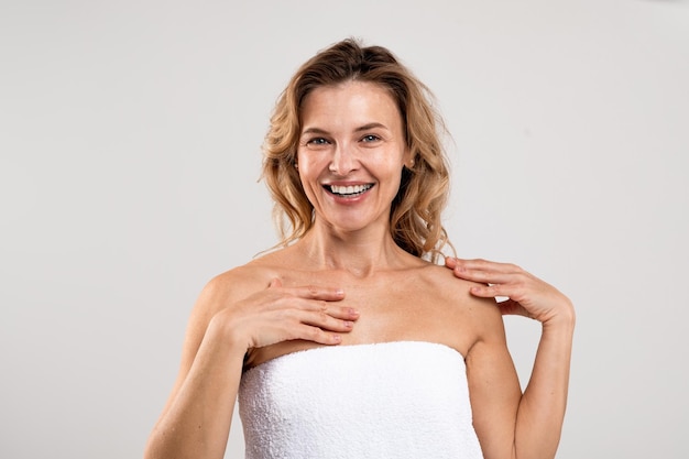 Body Care Portrait Of Cheerful Middle Aged Woman Standing Wrapped In Towel