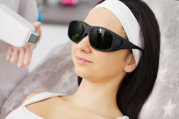 Body Care. Underarm Laser Hair Removal. Beautician Removing Hair Of Young Woman's Armpit. Laser Epilation Treatment In Cosmetic Beauty Clinic. Hairless Smooth And Soft Skin. Health And Beauty Concept.