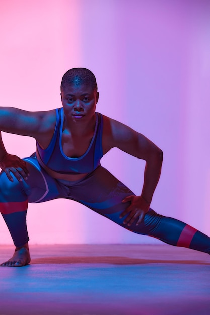 Body positive slimming African american woman in sportswear workout fashion studio shot Advertising photo copyspace