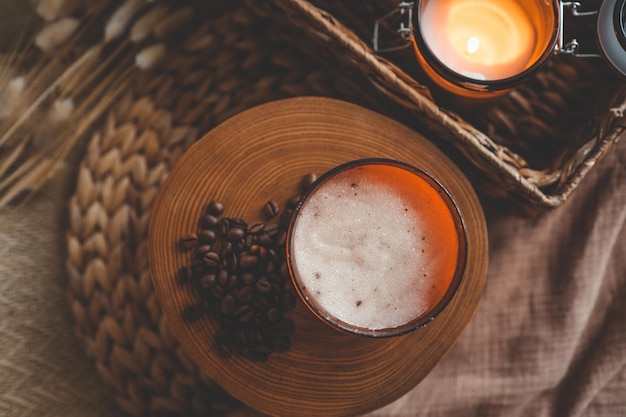 Body scrub of ground coffee sugar and coconut oil in glass jar on white rustic table homemade cosmetic for peeling and spa care top view