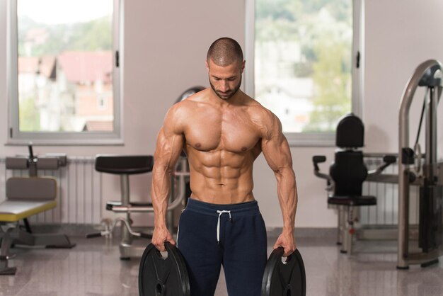 Bodybuilder Holding Weights In Hand