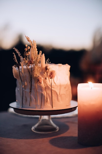 Boho wedding cake on the table in the evening