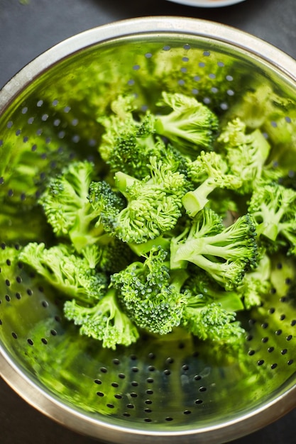 Boiled broccoli in metal colander closeup