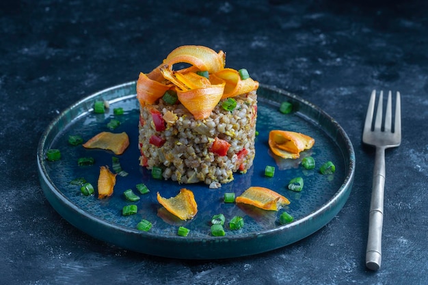 Boiled buckwheat with fried eggs red peppers carrots and onions