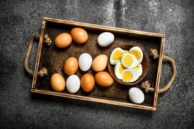 Boiled eggs in a bowl on a rustic background