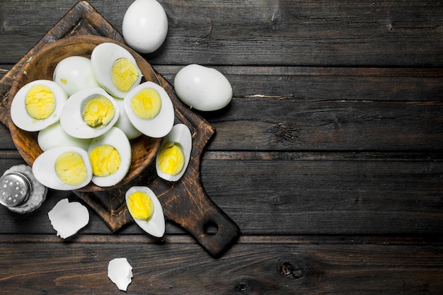 Boiled eggs in bowl with salt