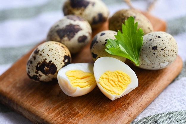 Boiled eggs food quail eggs on wooden plate breakfast eggs with fresh quail eggs and vegetable coriander on food table background