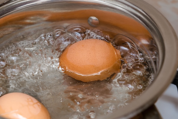 Photo boiled eggs in a small saucepan.