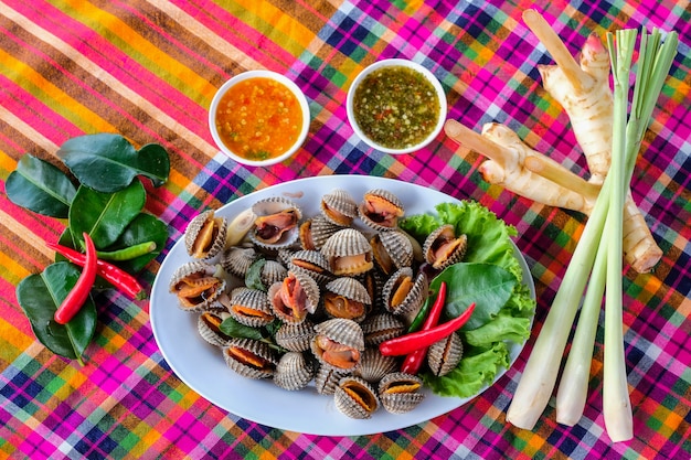 Boiled fresh cockles on lettuce vegetable for seafood serving