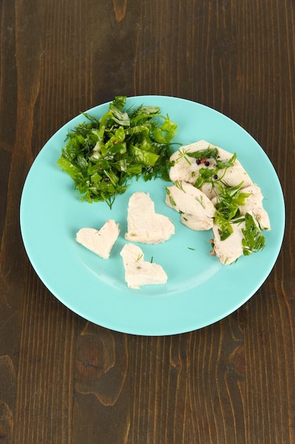 Boiled meat on plates on wooden table