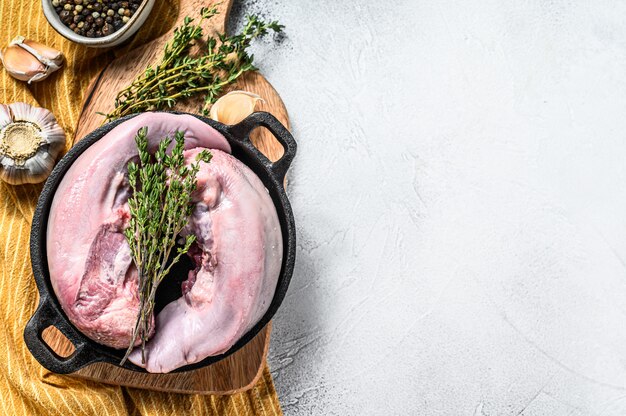 Boiled pork tongue with spices and herbs. Organic meat offal. White background.