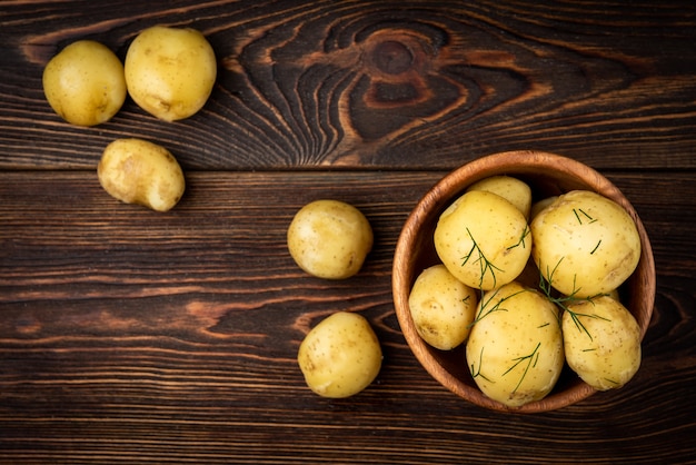 Boiled potato on dark wooden background.