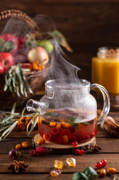 Boiling water is poured into a kettle with berries and spices