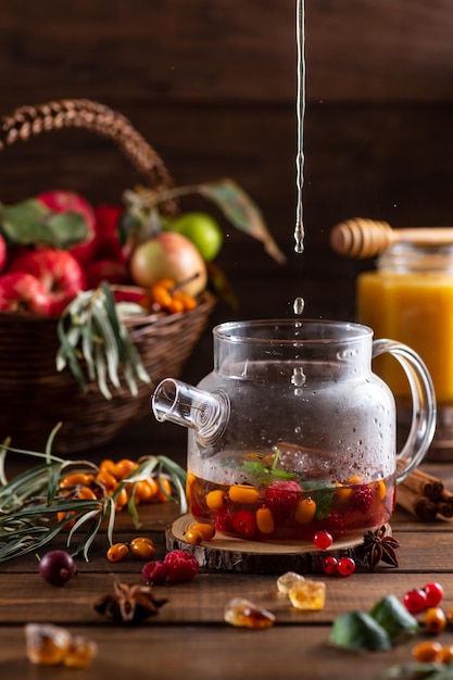 Boiling water is poured into a kettle with berries and spices