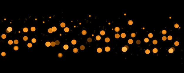 Bokeh Blurred abstract lights with yellow tones on black background Defocused Lights and Dust Particles Gold abstract bokeh background Mock up and overlay