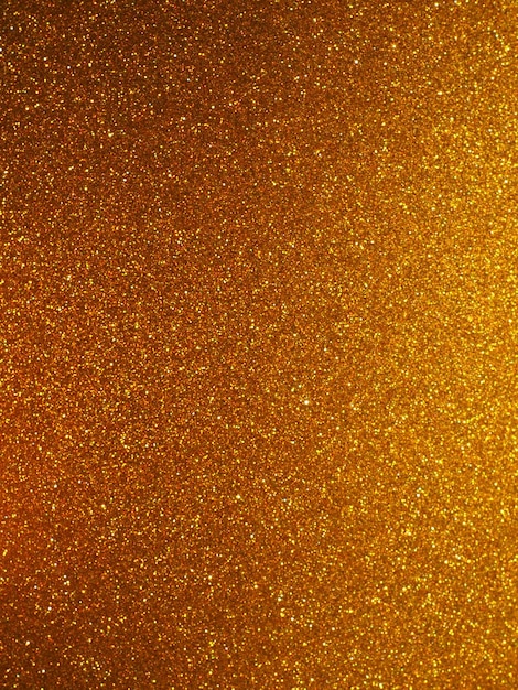 Bokeh light of gold glitters Golden glitter texture background Sparkling glitter wrapping paper with sequins and sparkles Festive golden bokeh and glitter Beautiful background