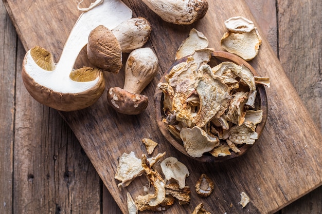 Boletus wild dried mushrooms set, on old dark wooden table background