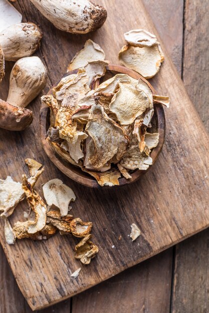 Boletus wild dried mushrooms set, on old dark wooden table background