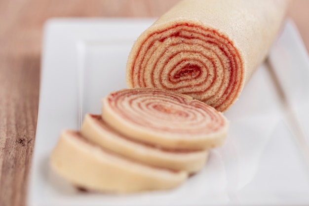 Bolo de rolo (swiss roll, roll cake) typical Brazilian dessert, from the state of Pernambuco. Sliced cake roll filled with Guava paste.