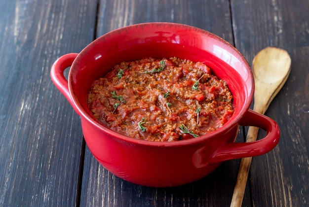 Bolognese sauce on a wooden background Italian cuisine