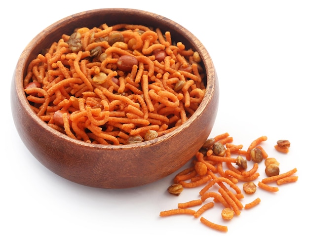 Bombay mix in wooden bowl over white background