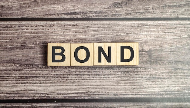 Bond word on wooden block A bond is a security that indicates that the investor has provided a loan to the issuer