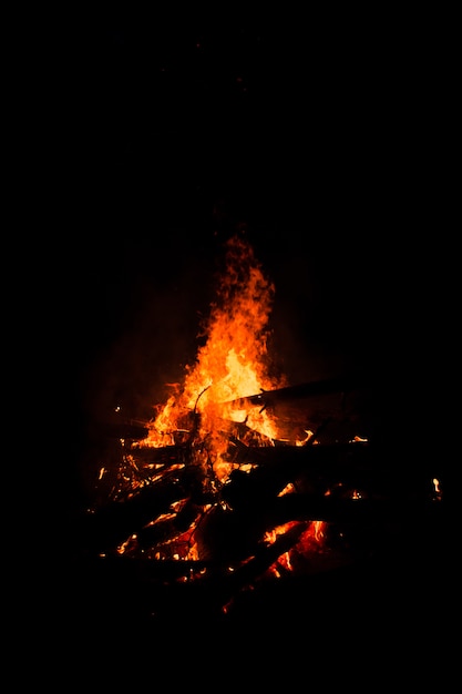 Bonfire burning trees at night. Bonfire burning brightly, heat, light,camping, big bonfire.