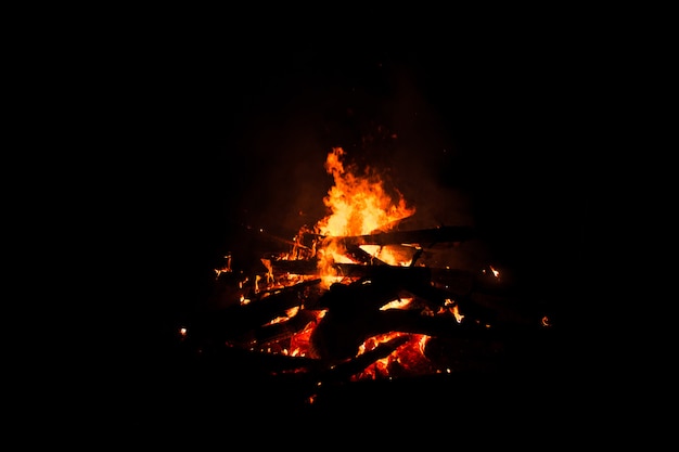 Bonfire burning trees at night. Bonfire burning brightly, heat, light,camping, big bonfire.