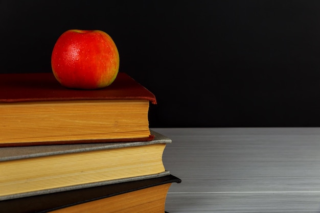 Book apple school board stack of books with a red apple and a clean blackboard