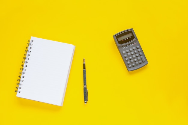 Book note and calculator on color background