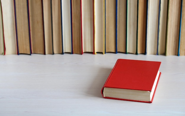 Book in a red cover on the table copy space science education literature