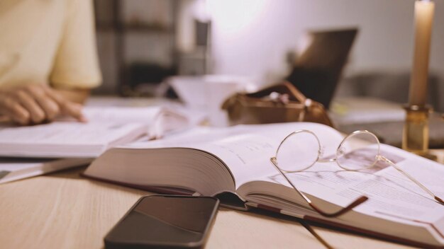 A book on a table with glasses on it