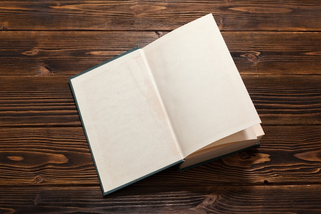 Book on wooden table. top view