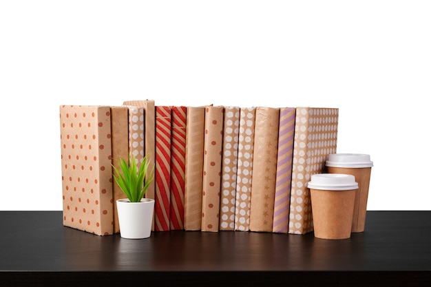 Books on black table against white background