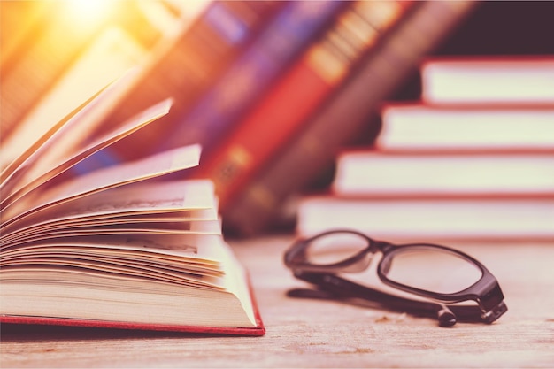 Books and glasses on  table  background,close up