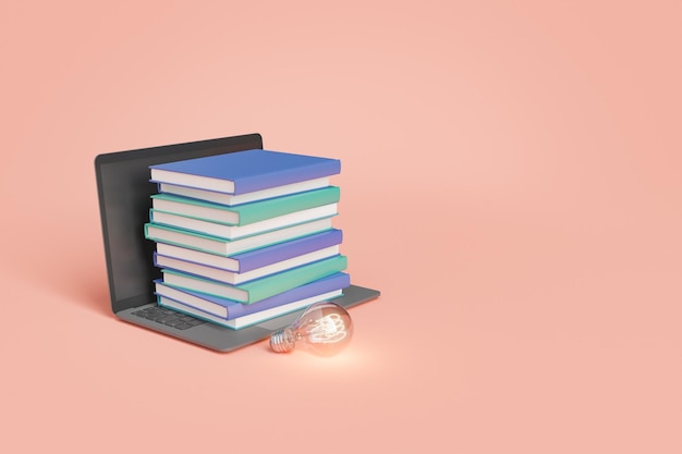 Books on laptop near glowing light bulb