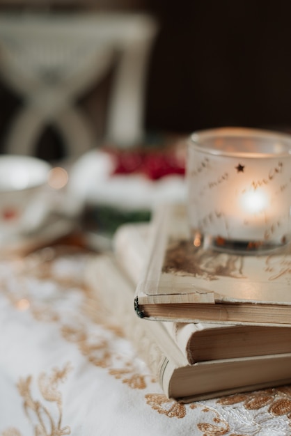 Books lie on the table with a white tablecloth close-up