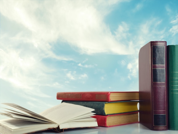 Books over the sky with clouds