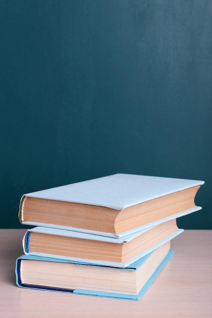 Books on table on board background