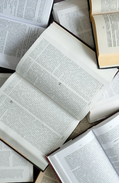 The books on the table. A lot of open books on the table. Read at home. Quarantine classes.