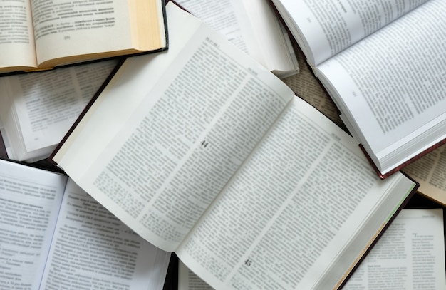 The books on the table. A lot of open books on the table. Read at home. Quarantine classes.