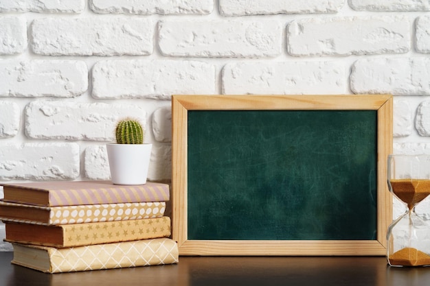 Books with picture frame on wooden table