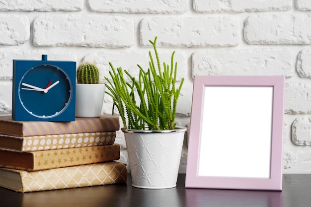 Books with picture frame on wooden table