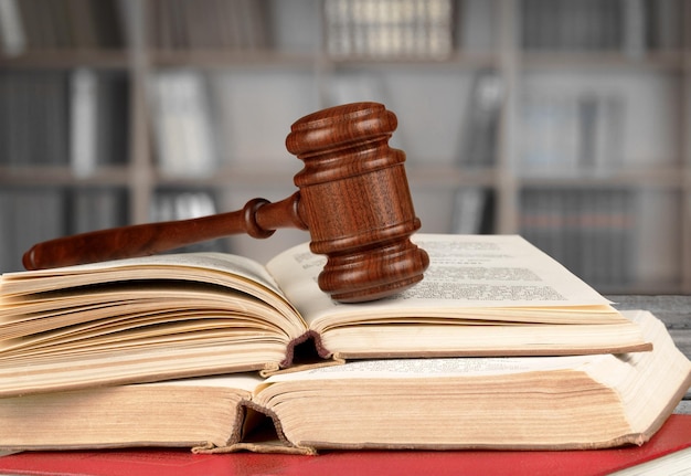 Books and wooden gavel on table. Justice concept