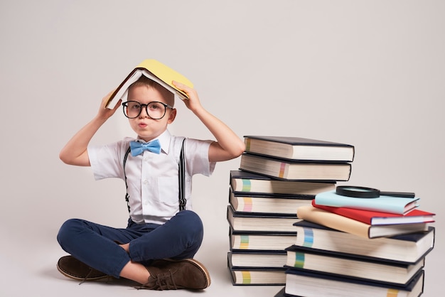 Bored child with stack of books